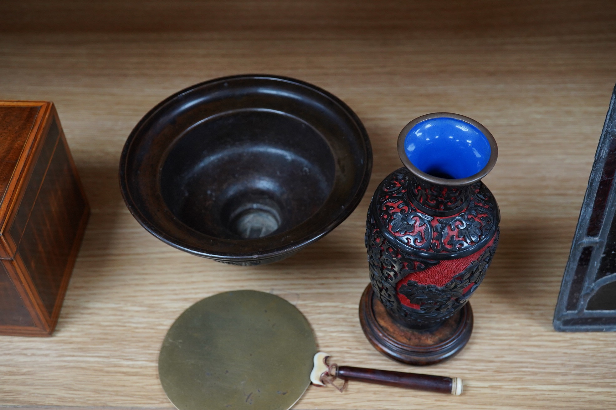 A Chinese bronze bowl, 17cm diameter, a lacquer vase, 15cm high, and a Chinese hand mirror with ivory inlay (3). CITES Submission reference 1UK5HNLM. Condition - fair to good